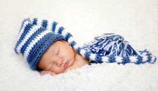 Sleeping baby in blue striped hat